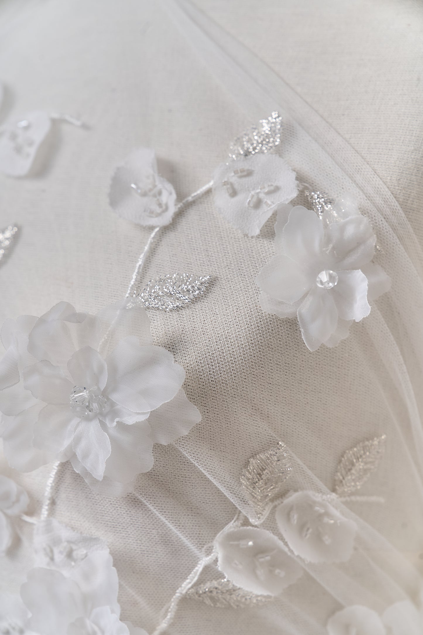S0699 - Embroidered tulle with 3D organza flowers, 3D chiffon leaves, silver lurex thread, off-white beads, and transparent rhinestones
