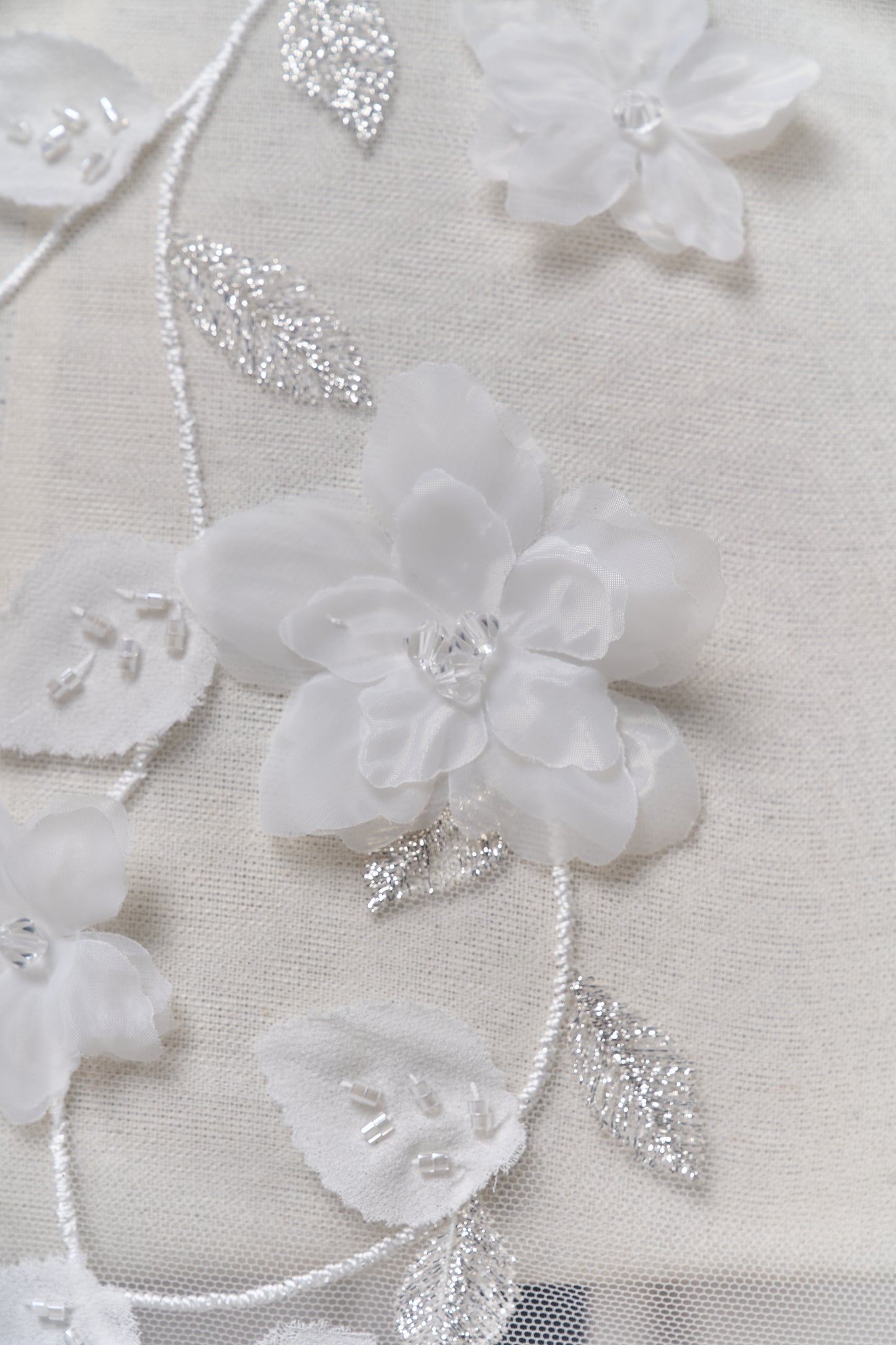 S0699 - Embroidered tulle with 3D organza flowers, 3D chiffon leaves, silver lurex thread, off-white beads, and transparent rhinestones