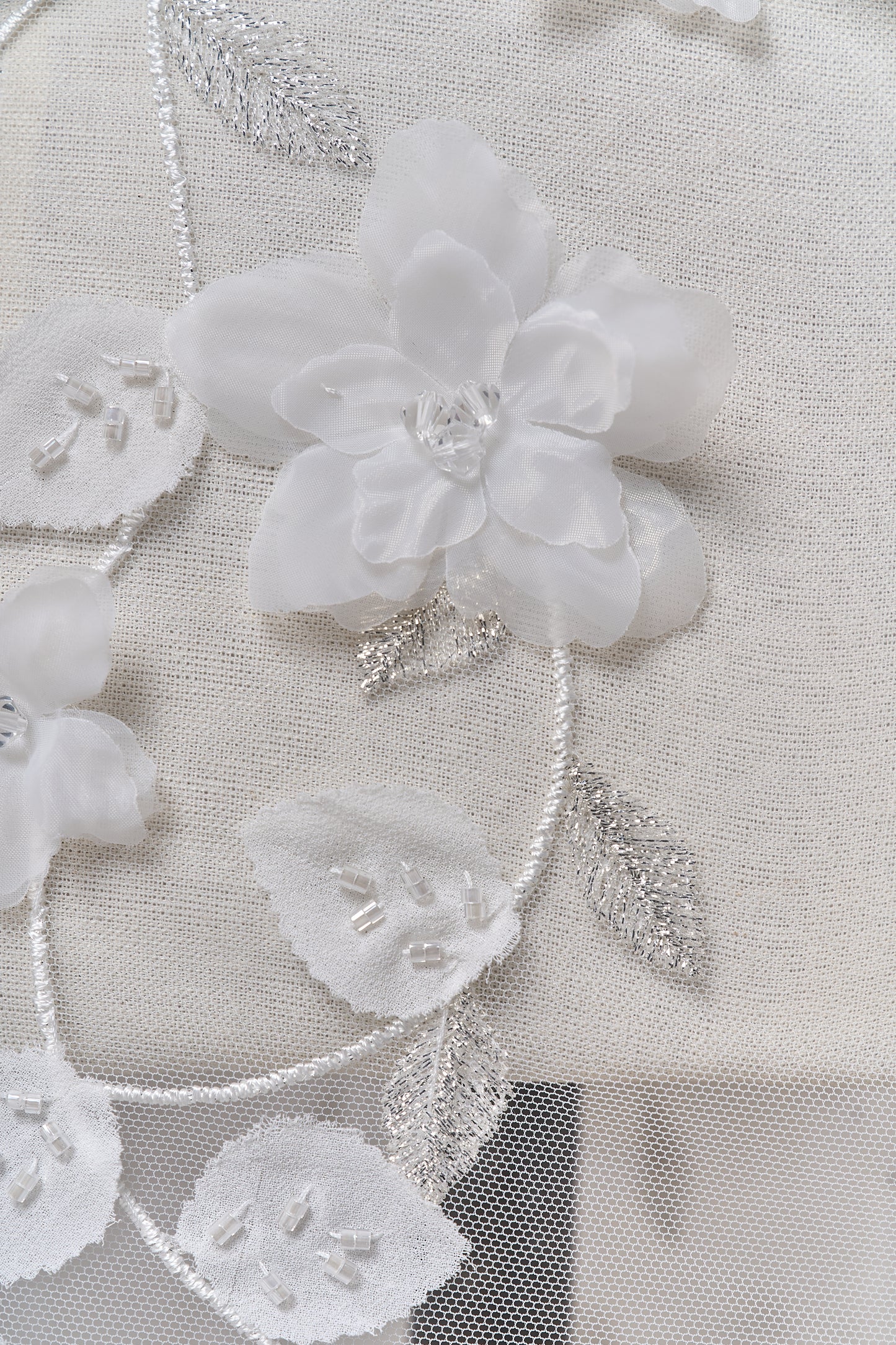 S0699 - Embroidered tulle with 3D organza flowers, 3D chiffon leaves, silver lurex thread, off-white beads, and transparent rhinestones
