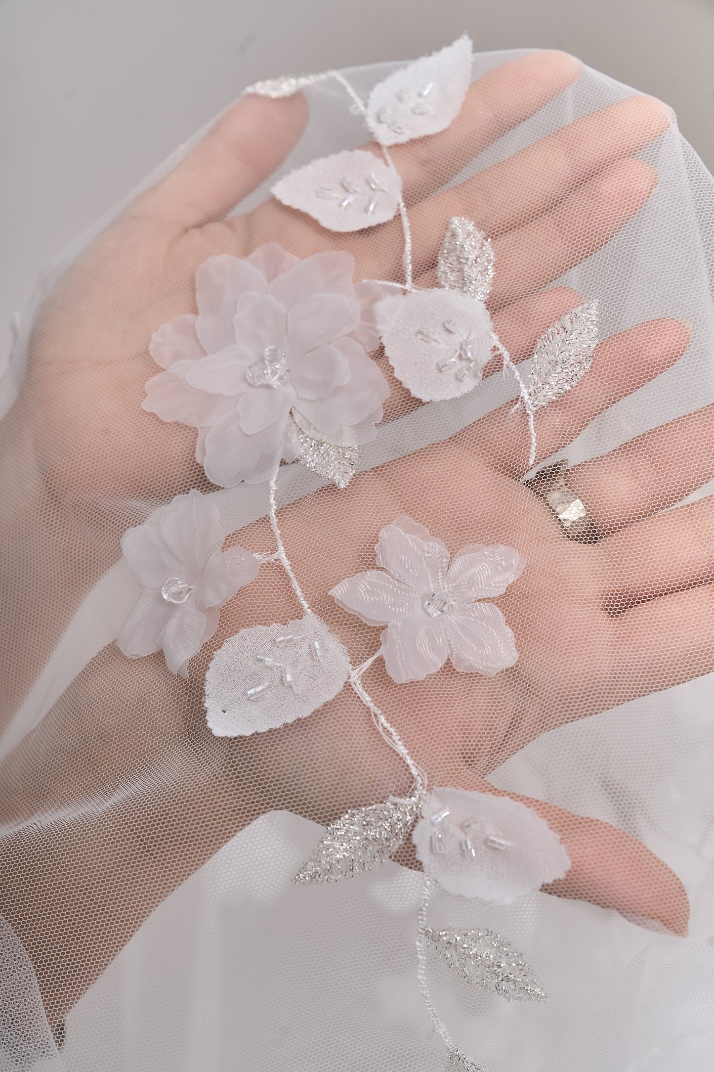 S0699 - Embroidered tulle with 3D organza flowers, 3D chiffon leaves, silver lurex thread, off-white beads, and transparent rhinestones