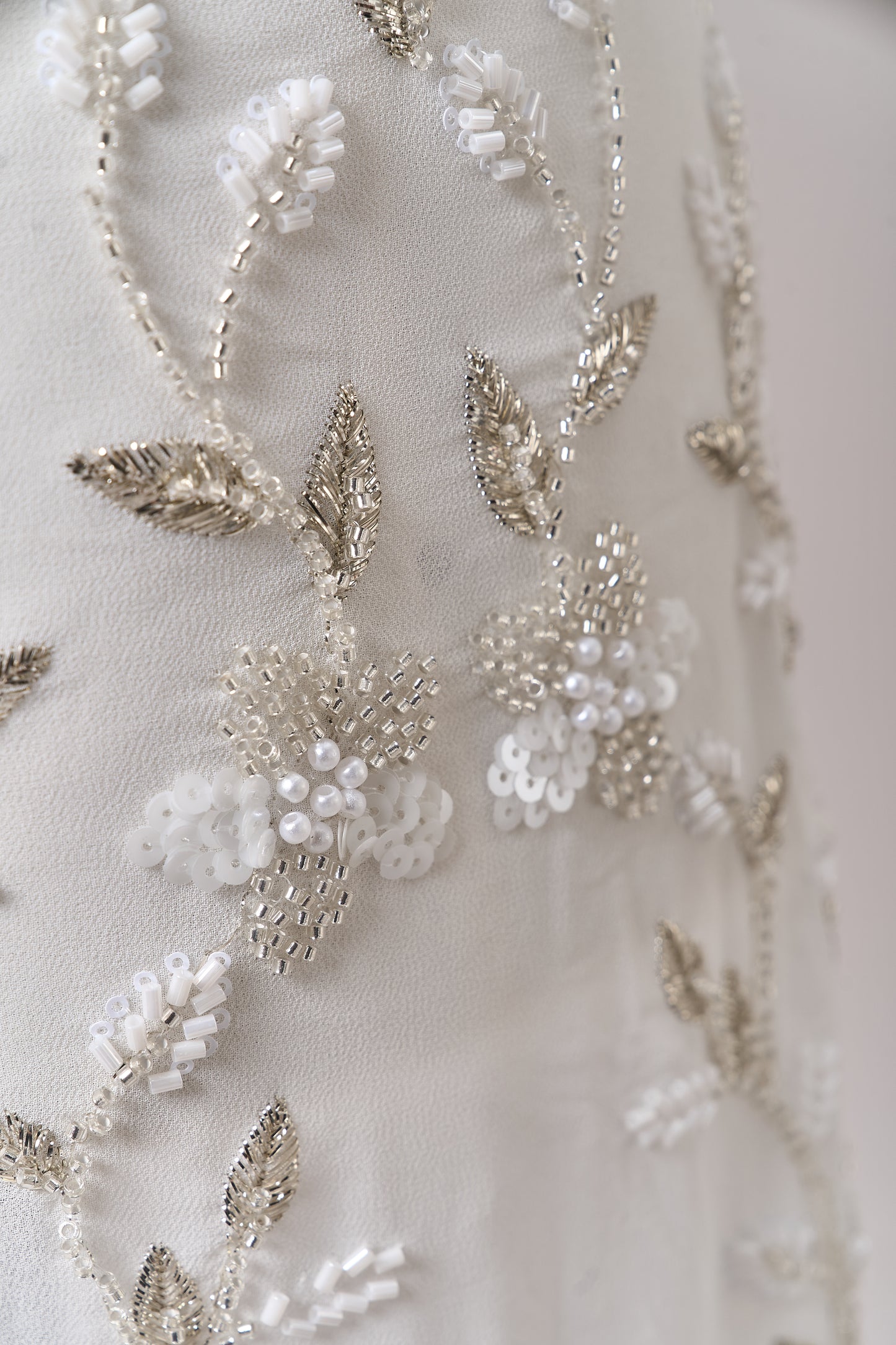 S0710 - Chiffon embroidered with silver metallic thread, silver beads, off-white pearls, long off-white bugle beads, and off-white sequins