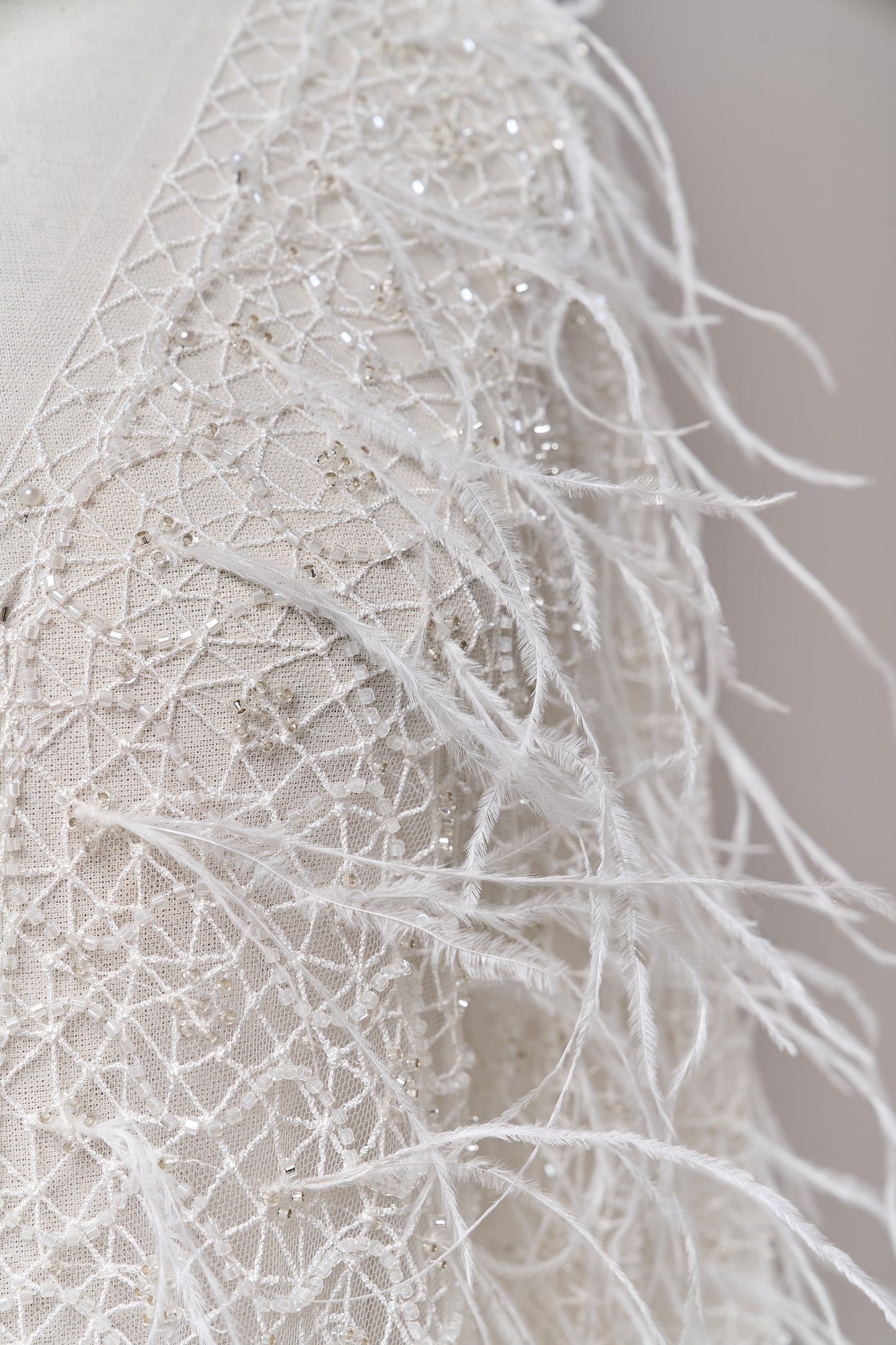 S0680 - Embroidered tulle with off-white and silver beads, transparent sequins, and real feathers