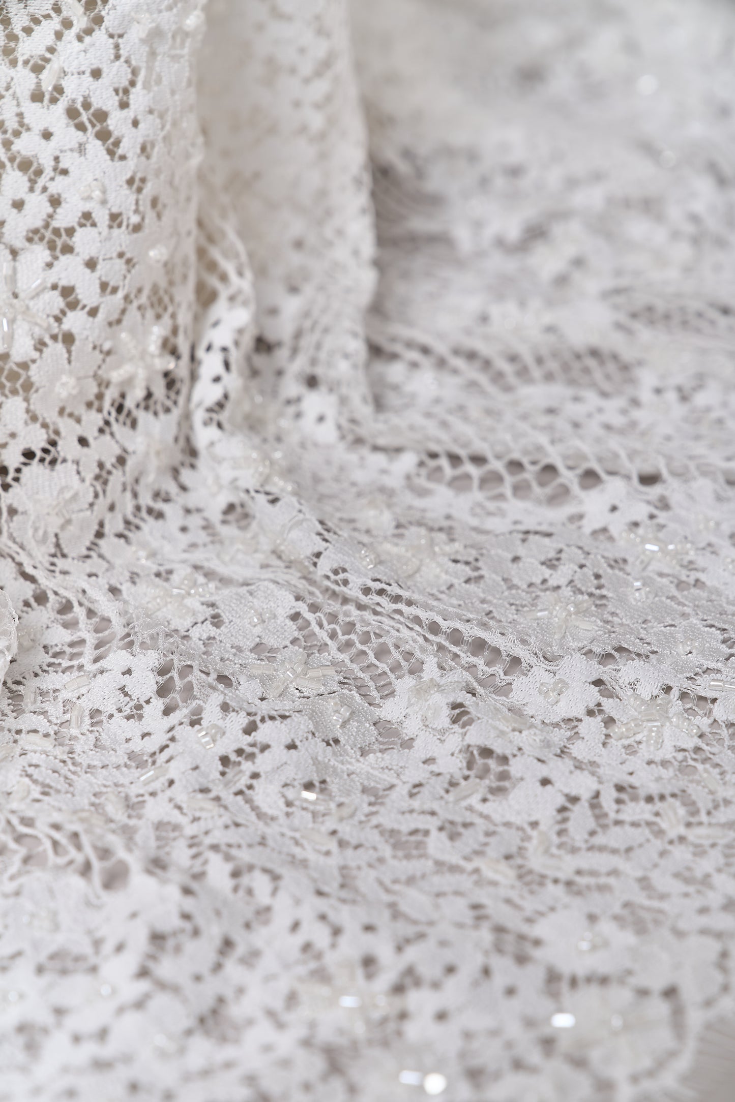S0679 - Embroidered lace with off-white &nbsp;beads, long off-white bugle beads, and transparent sequins