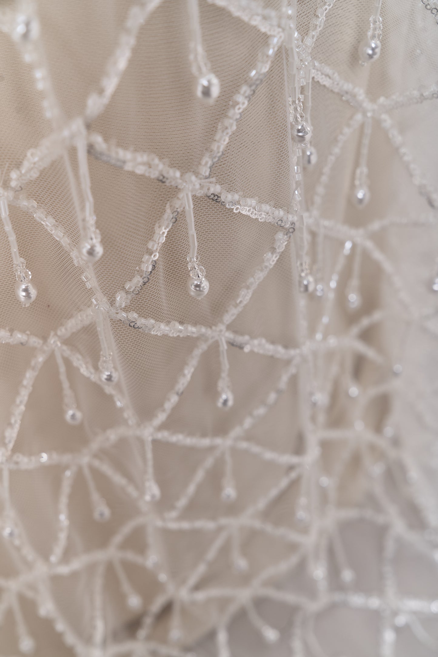 S0709 - Embroidered tulle with off-white beads, silver sequins, long off-white bugle bead fringe, transparent rhinestones, and nacre pearls