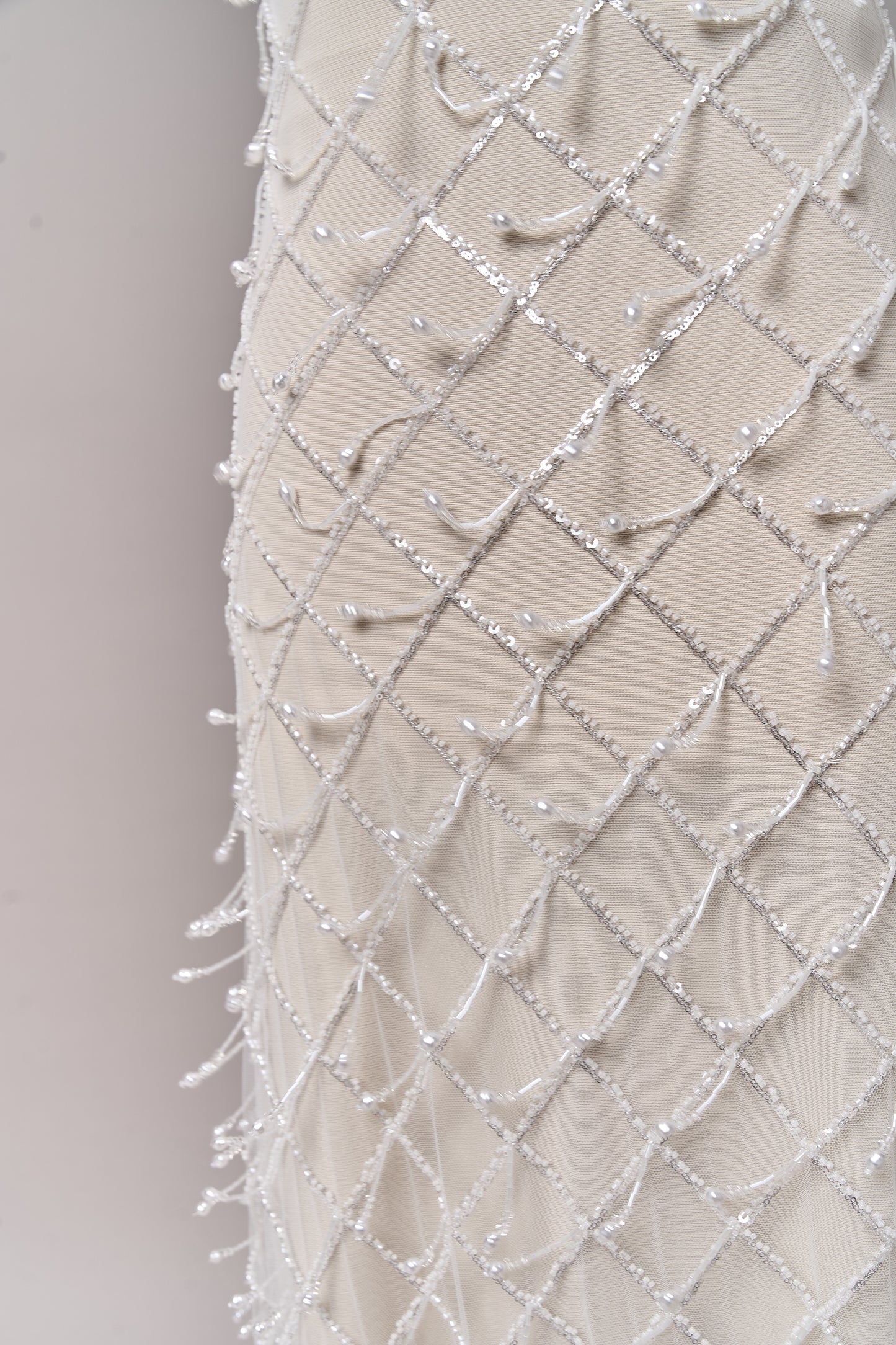 S0709 - Embroidered tulle with off-white beads, silver sequins, long off-white bugle bead fringe, transparent rhinestones, and nacre pearls